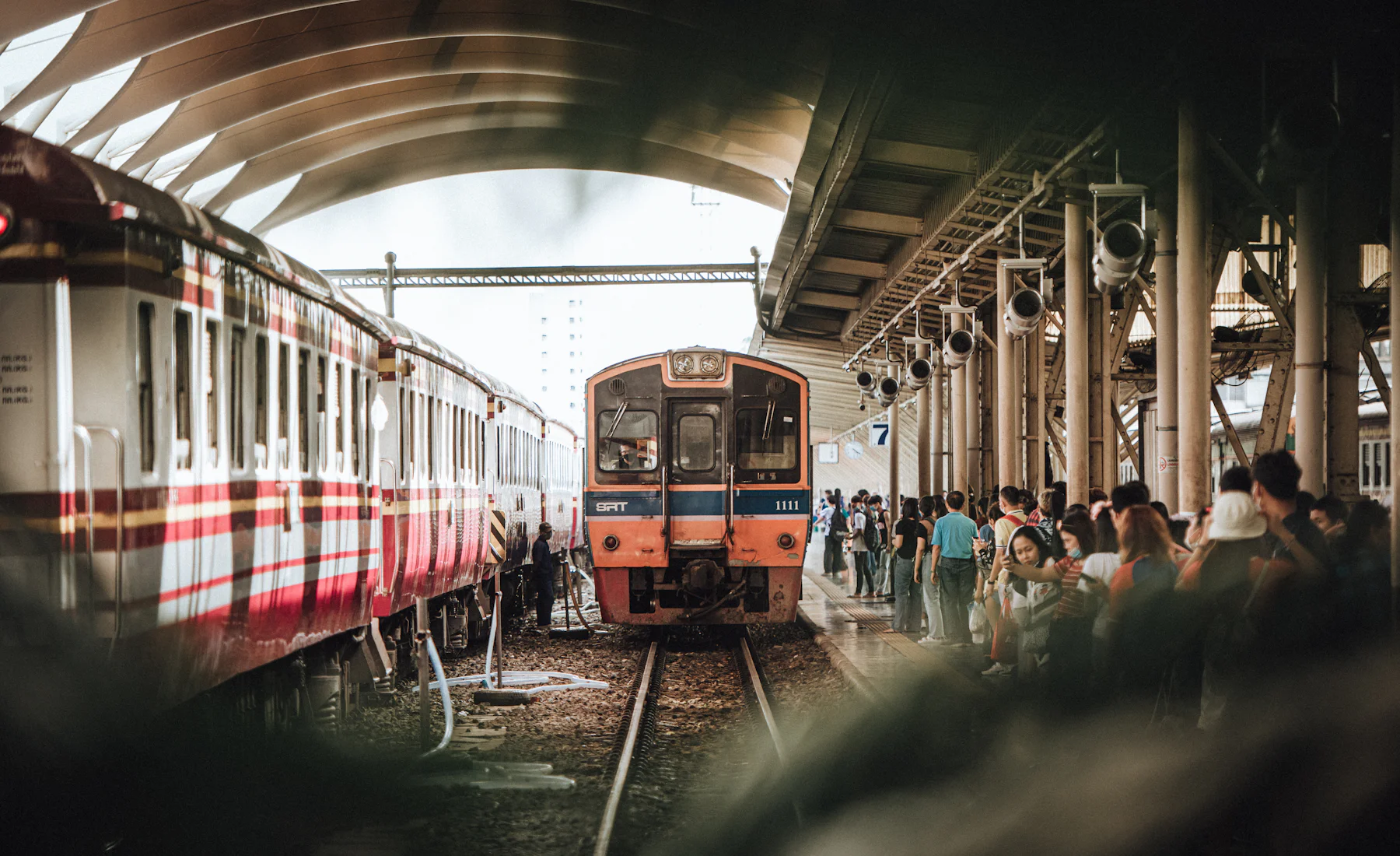Commuters on a Bangkok train — everyday BTS rides that earn points.