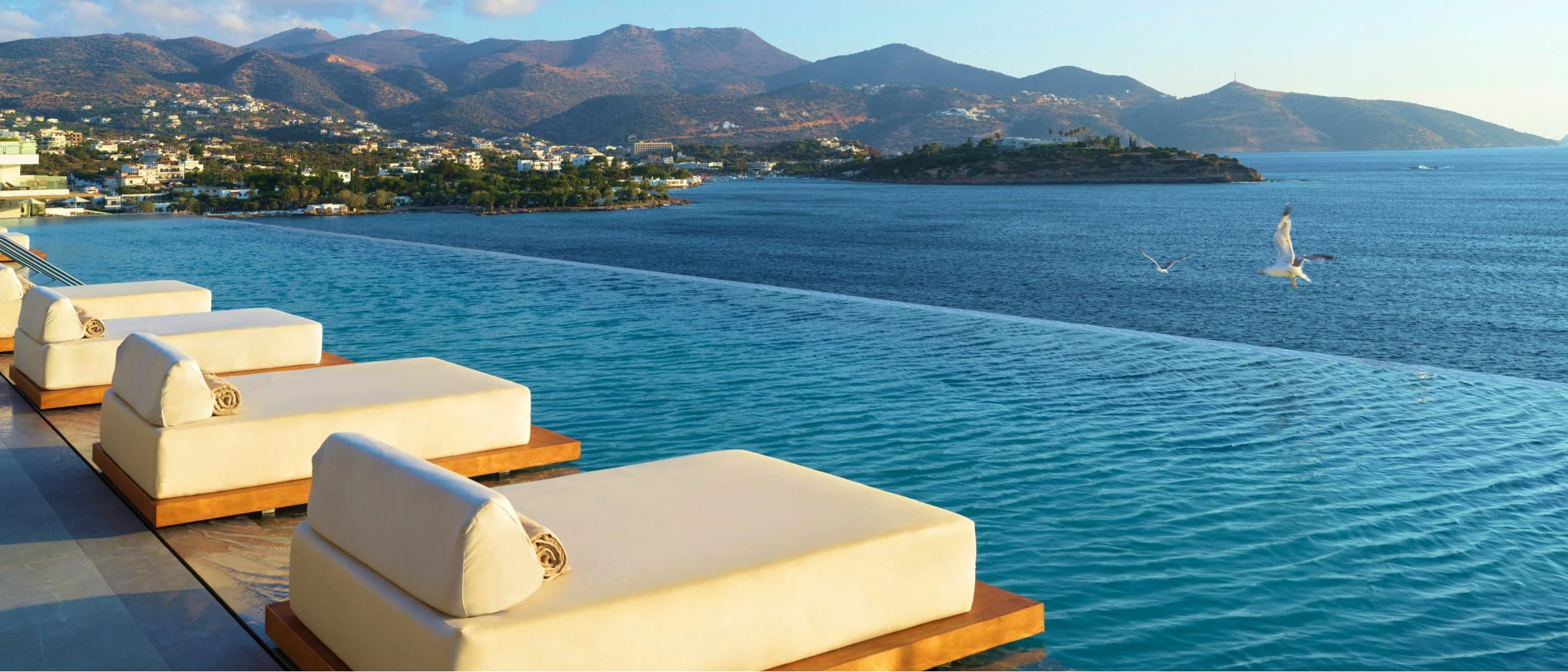 A resort pool on a bright day, standing in for the Year-1 hero goal: a family getaway.
